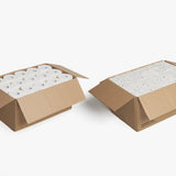 Two open brown cardboard boxes containing multiple white toilet paper rolls, compared to  fox fold toilet paper.